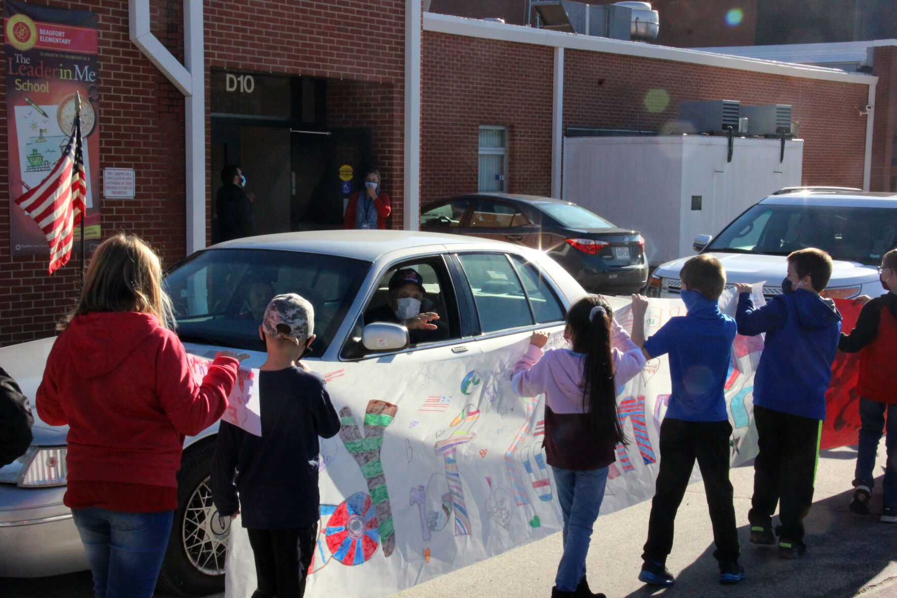 Sylvester Boland waves at Beaufort Elementary School students